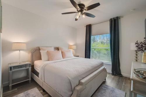 a bedroom with a bed with a ceiling fan and a window at South West Florida Family Home, 3 Bedroom,2 Bathroom, King bed suite, Close to Beaches, Parks, Fishing, Golfing, Kayaking in Rotonda West