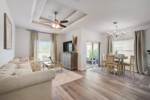 a living room with a couch and a dining room at South West Florida Family Home, 3 Bedroom,2 Bathroom, King bed suite, Close to Beaches, Parks, Fishing, Golfing, Kayaking in Rotunda-West