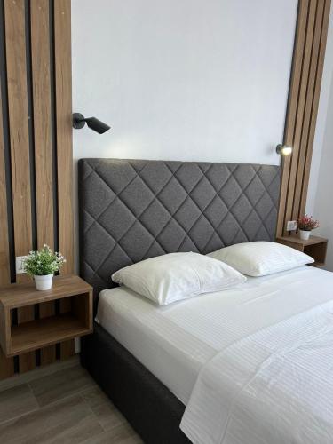 a bedroom with a bed with a gray headboard at Cold Bay Mansion Luxury Sea View Suites in Bar