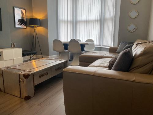 a living room with a couch and a table at Aspen House - Apartment 1 in Colwyn Bay