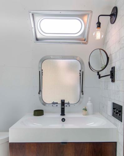 a bathroom with a white sink and a mirror at AutoCamp Yosemite in Midpines
