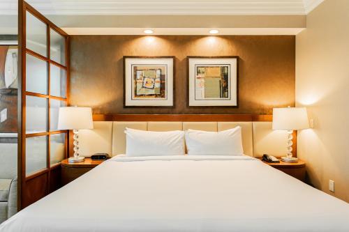a bedroom with a large bed and two lamps at MGM Signature, Centrally Located, Strip Views NO RESORT FEE in Las Vegas