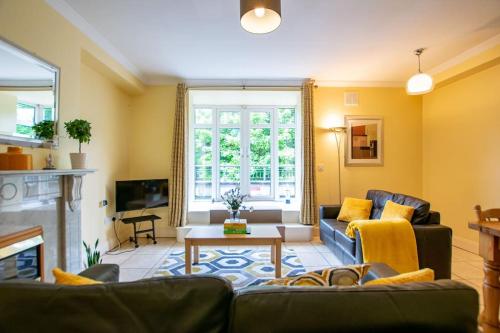 a living room with a couch and a fireplace at 3 - Superb Duplex at Gort Na Coiribe by Shortstays in Galway