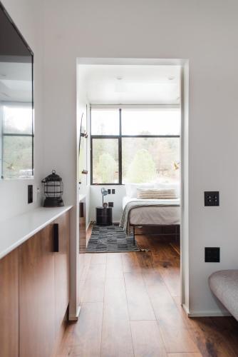 a bedroom with a bed and a large window at AutoCamp Yosemite in Midpines