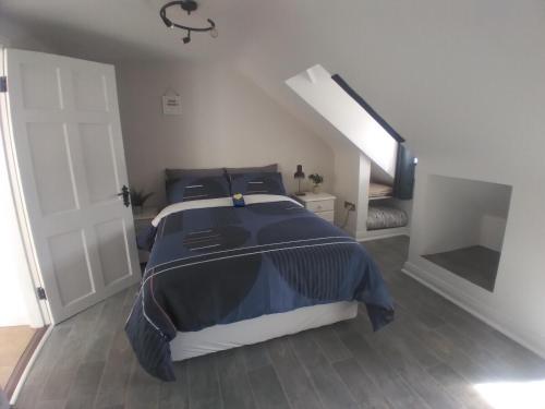 a bedroom with a bed and a white door at Up Stairs Double Apartment Innishannon Mariners Rest in Cork