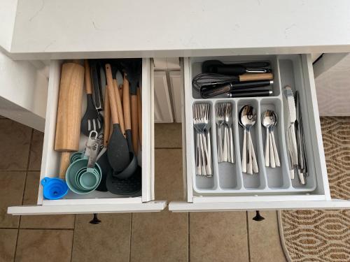 a drawer filled with utensils in a cabinet at Hot Tub-EV-AC-Kid Friendly-Arcade Game-Lake Access in Lake Arrowhead