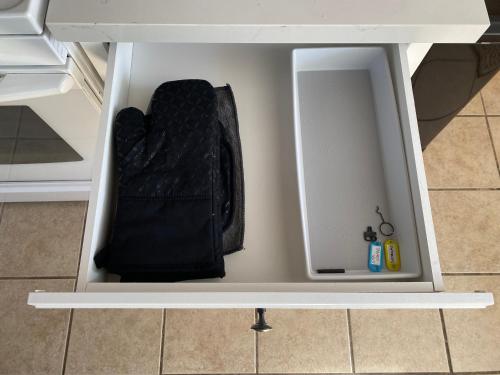 a white drawer with a black bag inside of it at Hot Tub-EV-AC-Kid Friendly-Arcade Game-Lake Access in Lake Arrowhead