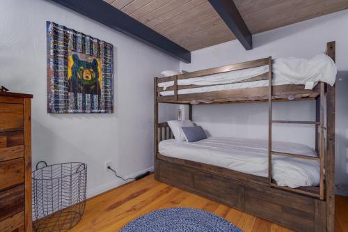 a bedroom with two bunk beds and a rug at Hot Tub-EV-AC-Kid Friendly-Arcade Game-Lake Access in Lake Arrowhead