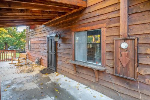 a wooden house with a window on the side of it at Hot Tub-EV-AC-Kid Friendly-Arcade Game-Lake Access in Lake Arrowhead