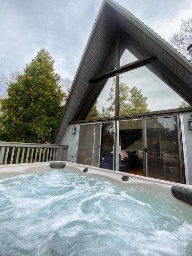 a hot tub in front of a house at Hot Tub-EV-AC-Kid Friendly-Arcade Game-Lake Access in Lake Arrowhead