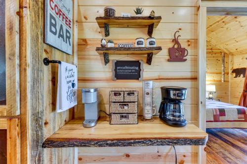 a wooden cabin with a counter with a coffee maker on it at Mountain View and Fire Pit Updated Murphy Cabin! in Murphy