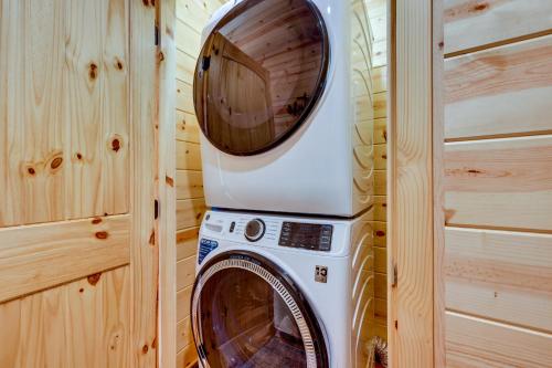 a washer and dryer in a tiny house at Mountain View and Fire Pit Updated Murphy Cabin! in Murphy