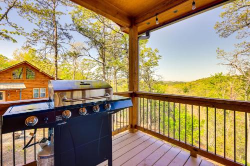 a grill on the deck of a cabin with a view at Mountain View and Fire Pit Updated Murphy Cabin! in Murphy