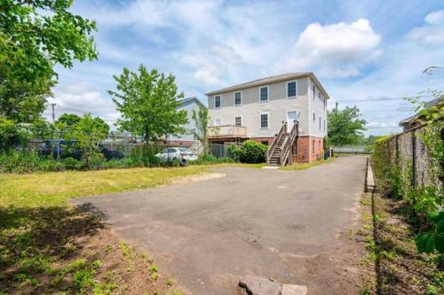 an empty driveway in front of a house at Gorgeous Waterfront 2 Bedroom 1 Bath Modern Home. in New Haven