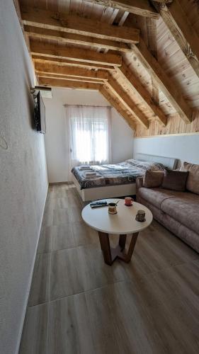 a living room with a couch and a table at Iva Lux Apartments in Žabljak