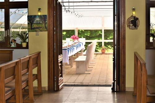 a dining room with a table with a white table cloth at Stadnina Koni Kierzbuń in Barczewo