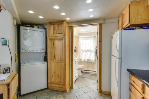 a kitchen with a white refrigerator and a sink at Idaho Springs Cabin with Hot Tub on Half Acre! in Idaho Springs