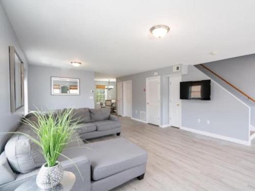 a living room with a couch and a tv at Gorgeous Waterfront 3 Bedroom, 1.5 Bathroom Unit. in New Haven