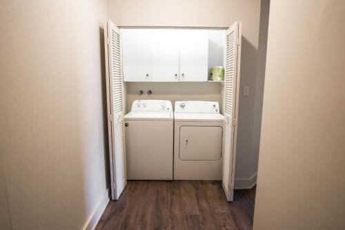 a small laundry room with a washer and dryer at Le Downtown Tremblant • Logement in Mont-Tremblant