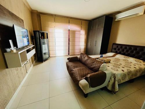 1 dormitorio con 1 cama y 1 sofá en Junior Suite a few minutes from shopping centers and airport, en Guayaquil
