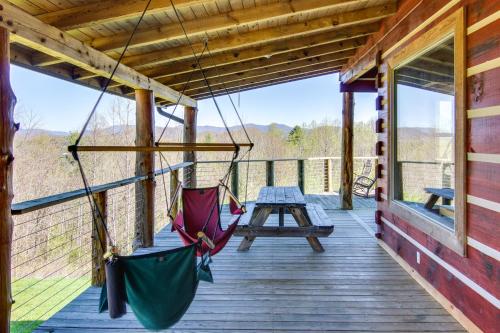 a porch with two hammocks and a picnic table at Mountain View and Fire Pit Rustic Marshall Getaway! in Marshall