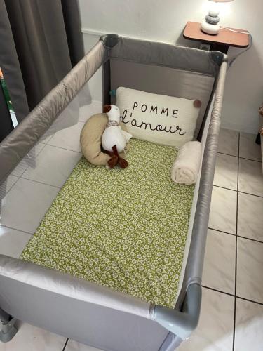 a baby crib with two stuffed animals sitting on it at PK 35 in Apomaoro