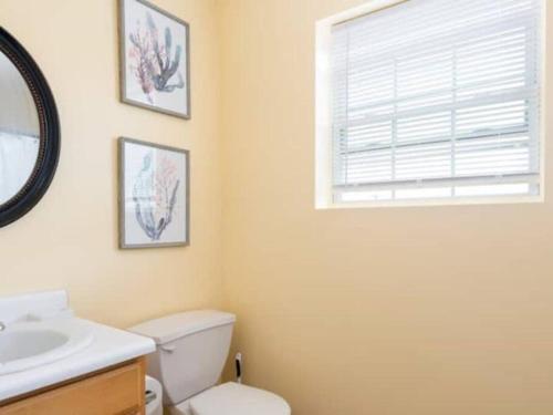 a bathroom with a toilet and a sink and a window at Gorgeous Waterfront 2:1 - 2 houses in 1 building. in New Haven