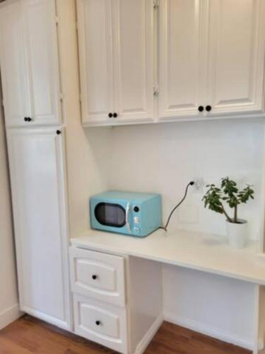a blue microwave sitting on a counter in a kitchen at Private entry 2b1b guest suite in San Jose