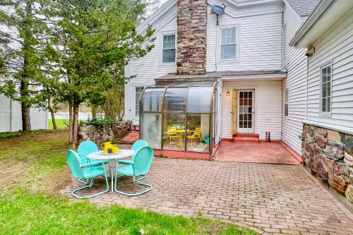 a patio with a table and chairs in front of a house at Maplewood Manor in Colchester