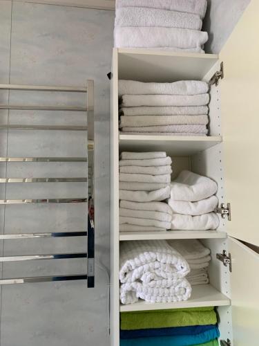 a closet with white towels on shelves at KAB Guesthouse in Bogen