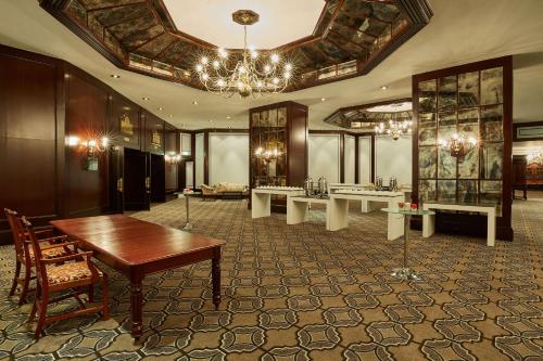 a large room with tables and a chandelier at Southern Sun Cape Sun in Cape Town