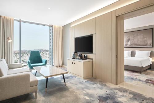 a hotel room with a bed and a tv at Radisson Blu Hotel Riyadh Convention and Exhibition Center in Riyadh