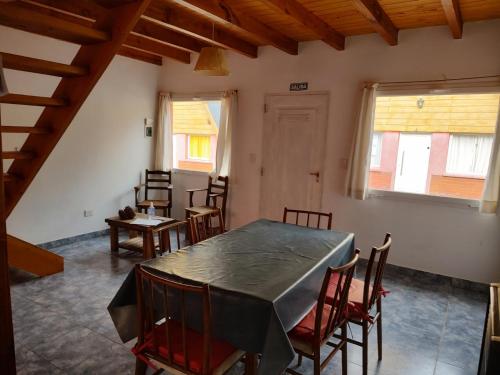 a dining room with a table and chairs at COMPLEJO AIKEN CURA in Junín de los Andes