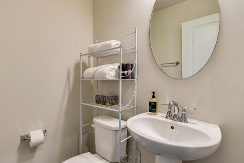 a bathroom with a toilet and a sink and a mirror at Spacious Home with Fireplace - Near Golf! in Brownsburg