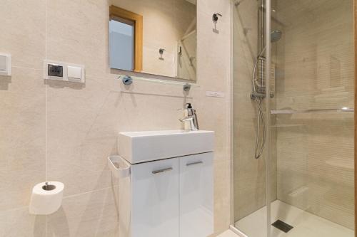 a bathroom with a white sink and a shower at Apartament Stegna Marine in Stegna
