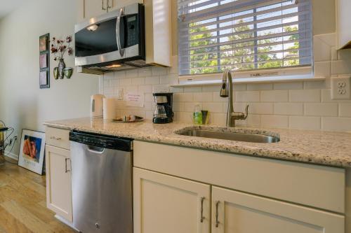 a kitchen with a sink and a microwave at Sunny Apex Vacation Rental with Pool Access! in Apex