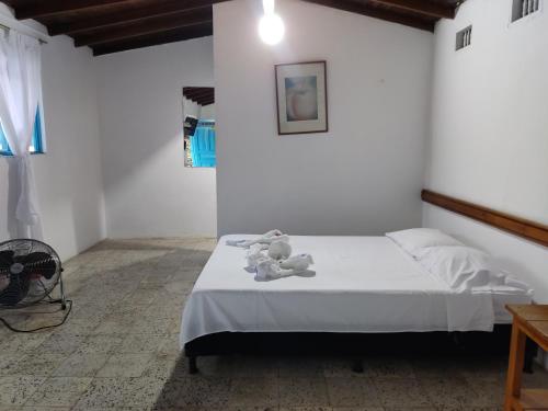 a bedroom with a bed with two teddy bears on it at Hosteria Puerta del Nus in Cisneros