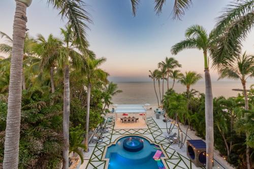 an aerial view of a resort with palm trees at Beachfront Villa at Islamorada BY THE GLAMHOMES in Islamorada