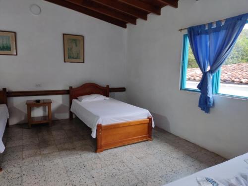 a bedroom with two beds and a window at Hosteria Puerta del Nus in Cisneros