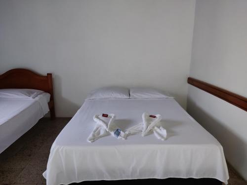 a bed with two pairs of underwear on it at Hosteria Puerta del Nus in Cisneros