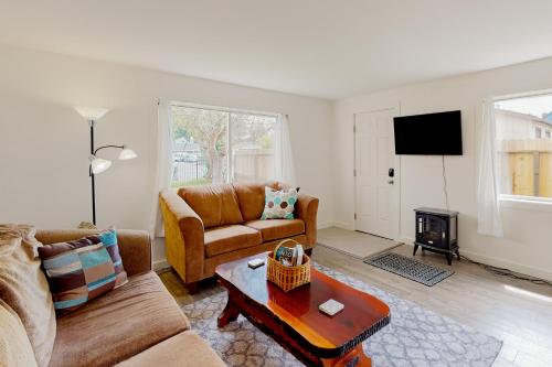 a living room with a couch and a fireplace at Cedar Street Cottage in Eureka