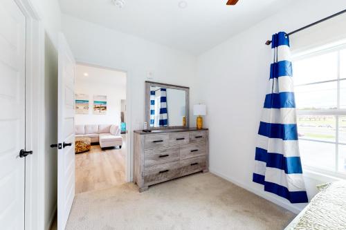 a bedroom with a dresser and a mirror at 21 Rehoboth Beach House --- 20494 Coastal Highway, Unit #21 in Rehoboth Beach