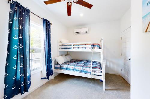 a bedroom with a bunk bed and a window at 21 Rehoboth Beach House --- 20494 Coastal Highway, Unit #21 in Rehoboth Beach