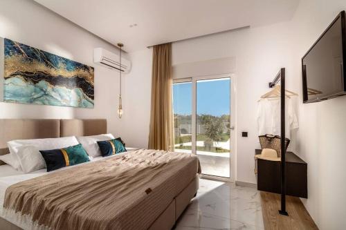 a bedroom with a bed and a large window at Melissia Luxury Villa in Zakynthos Town