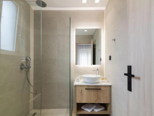 a bathroom with a sink and a glass shower at Melissia Luxury Villa in Zakynthos Town