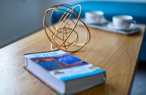 a book and a wire sitting on a table at Galilee Hills - Resort & Suites in Maghār