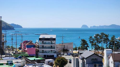 an aerial view of a city with the ocean at Oedo Tour Pension in Geoje 