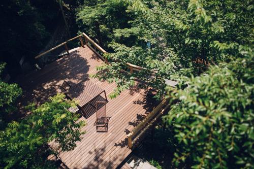 an overhead view of a wooden deck with trees at Villa Yumigahama in Minamiizu