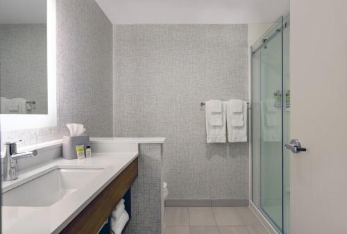 a bathroom with a sink and a shower at Holiday Inn Express & Suites - Collingwood in Collingwood