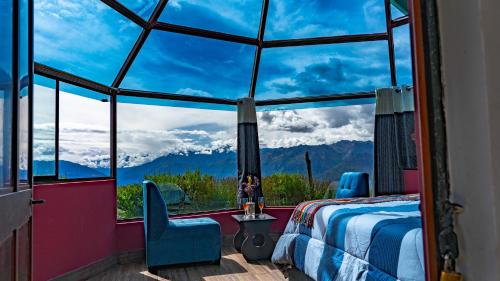 a bedroom with a large window with a view of mountains at Sky Dome Peru in Cusco